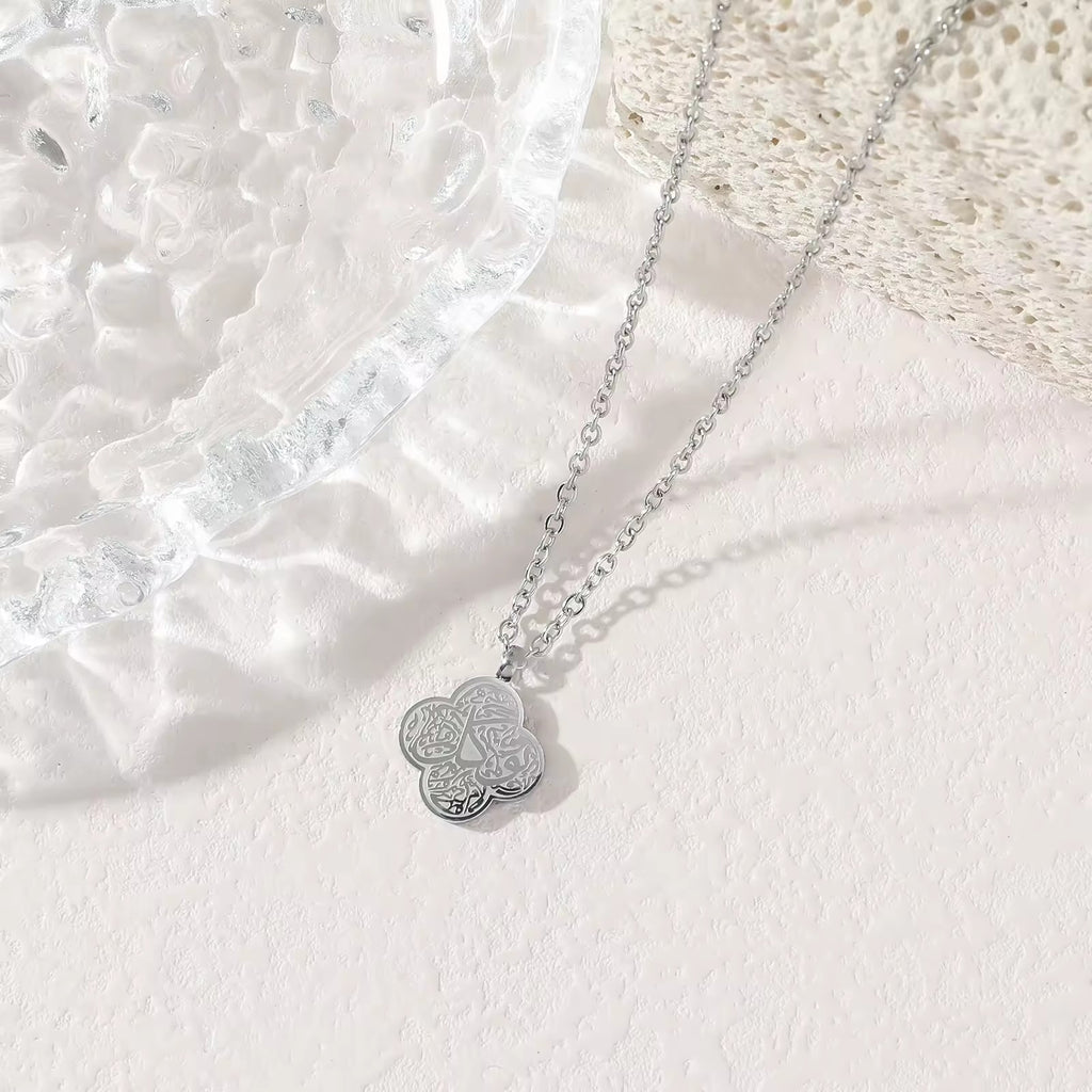 Silver four-leaf clover Shukr Arabic calligraphy pendant necklace on white background
