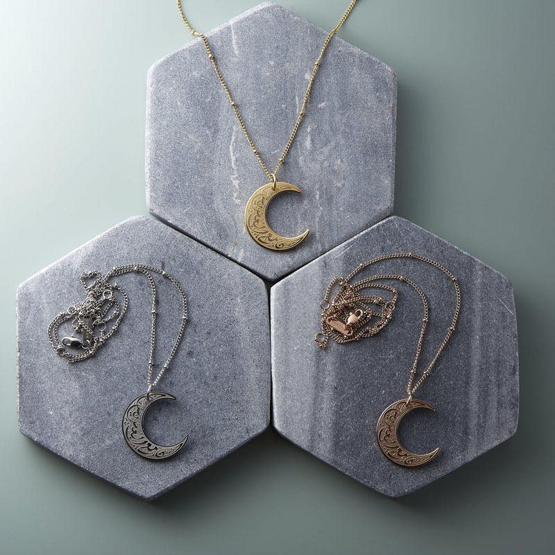Artistic flat lay of CIGAONI crescent moon jewelry - Premium gift ideas for Eid, Ramadan, and special milestones

