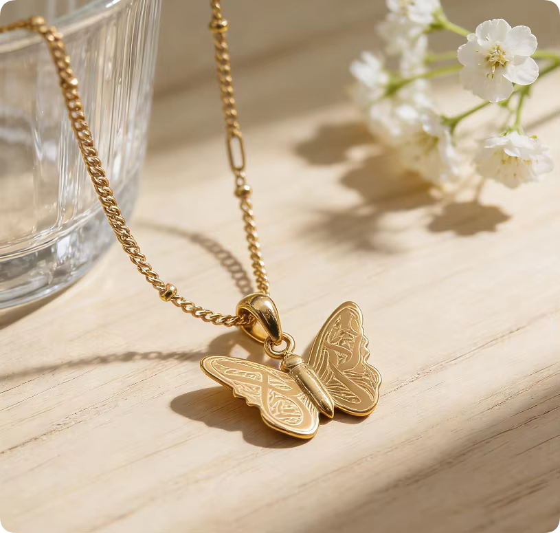 Gold butterfly necklace flat lay with soft natural lighting - CIGAONI
