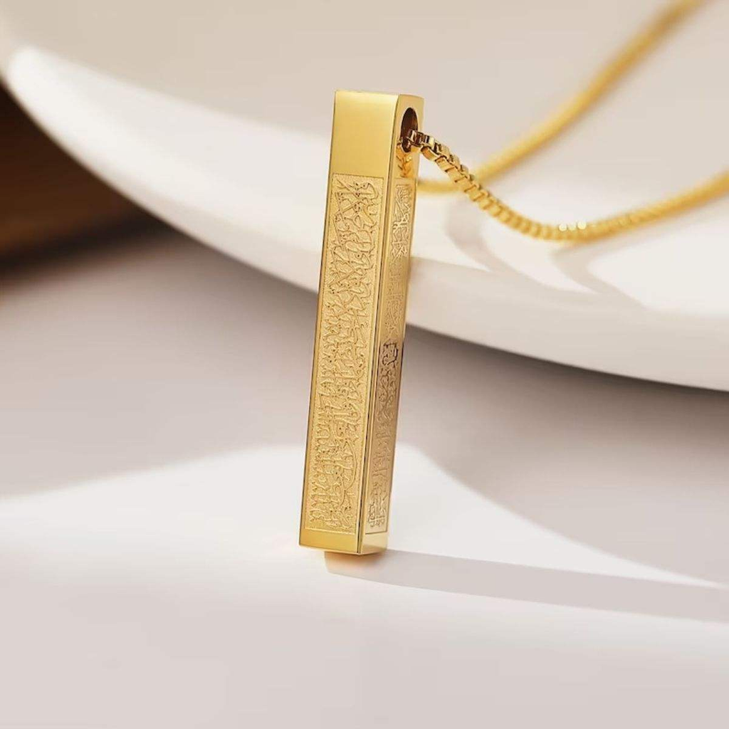 Premium catalog shot of CIGAONI gold vertical bar necklace - 18K gold plated sacred architecture jewelry on emerald silk backdrop