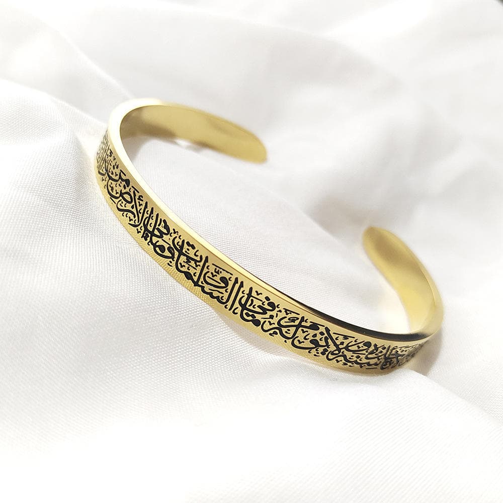 CIGAONI 18K gold Ayatul Kursi open cuff bangle with black Arabic calligraphy engraving on white silk fabric

