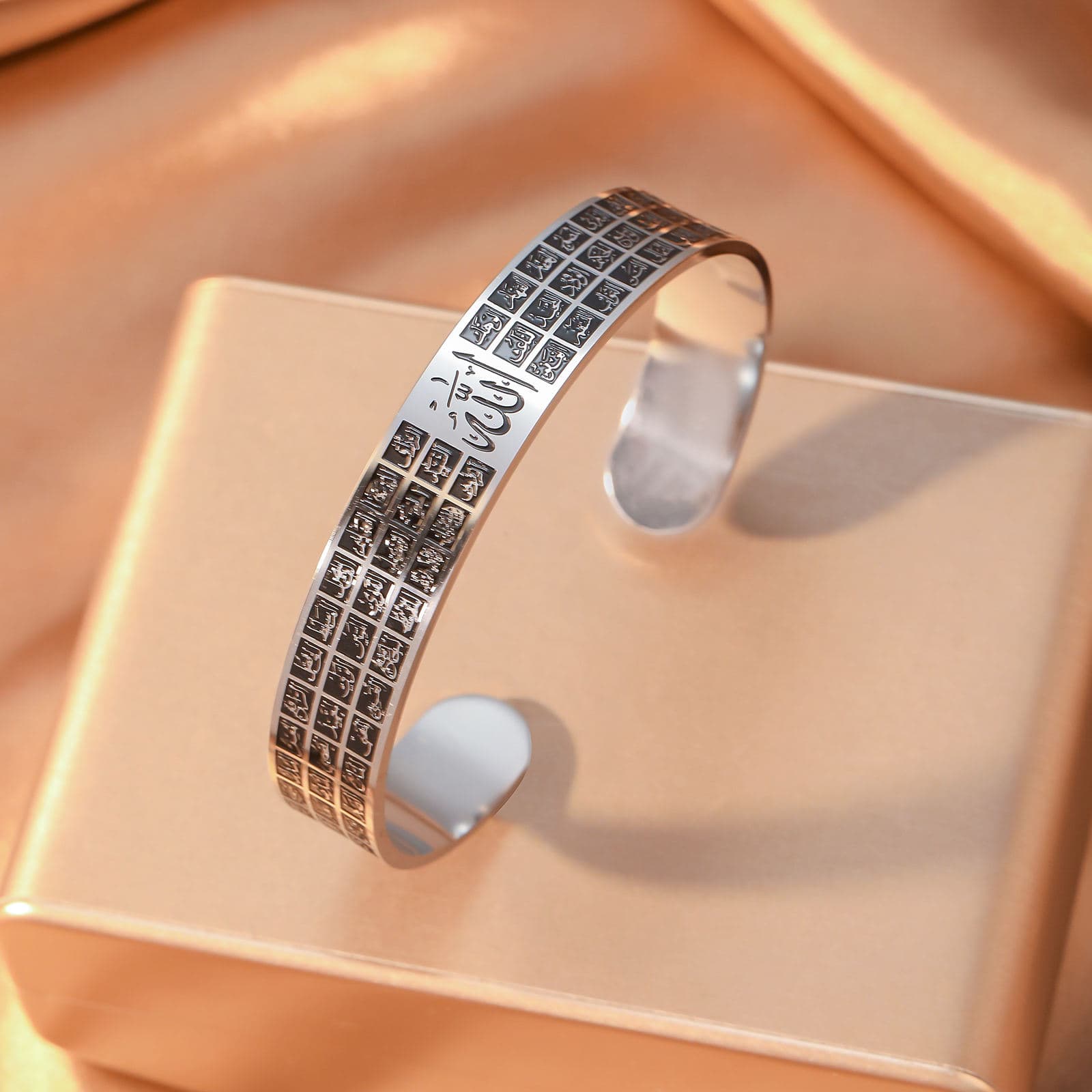 CIGAONI silver Asma-ul-Husna open cuff bangle with Allah calligraphy and 99 Names grid engraving on display stand