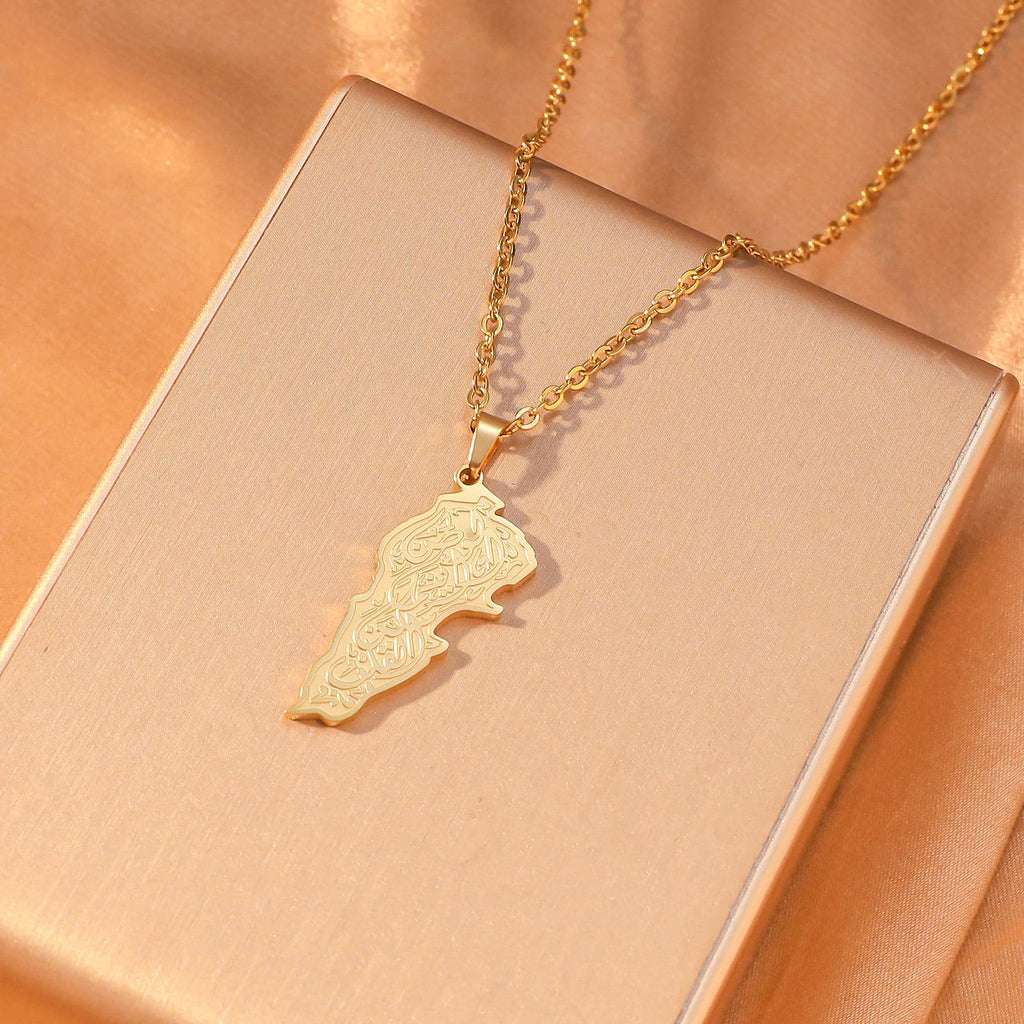CIGAONI Sacred Soil Gold Palestine Map Arabic Calligraphy Pendant Close-Up on Peach Background