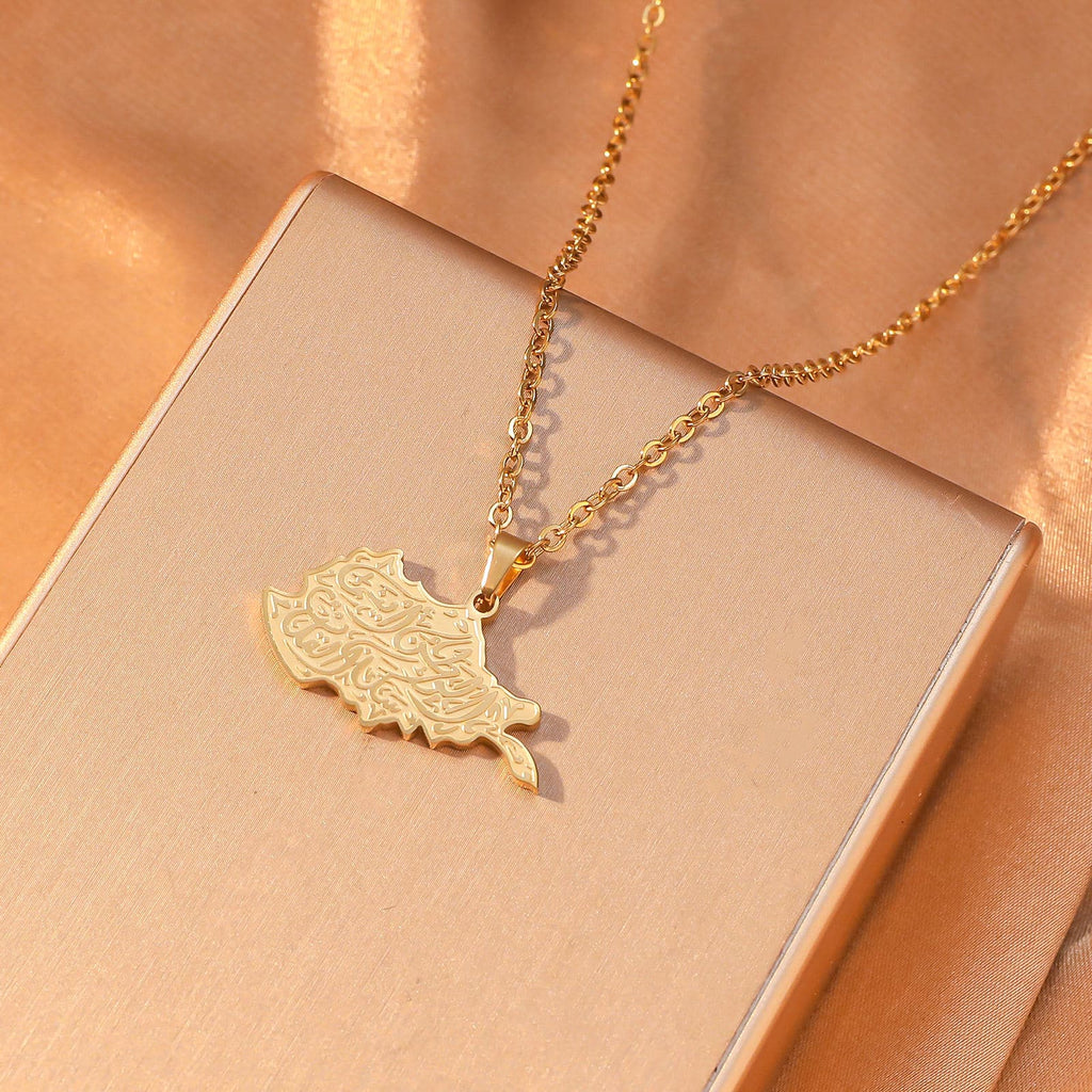 CIGAONI Sacred Soil Gold Iraq Map Arabic Calligraphy Pendant Close-Up on Peach Background