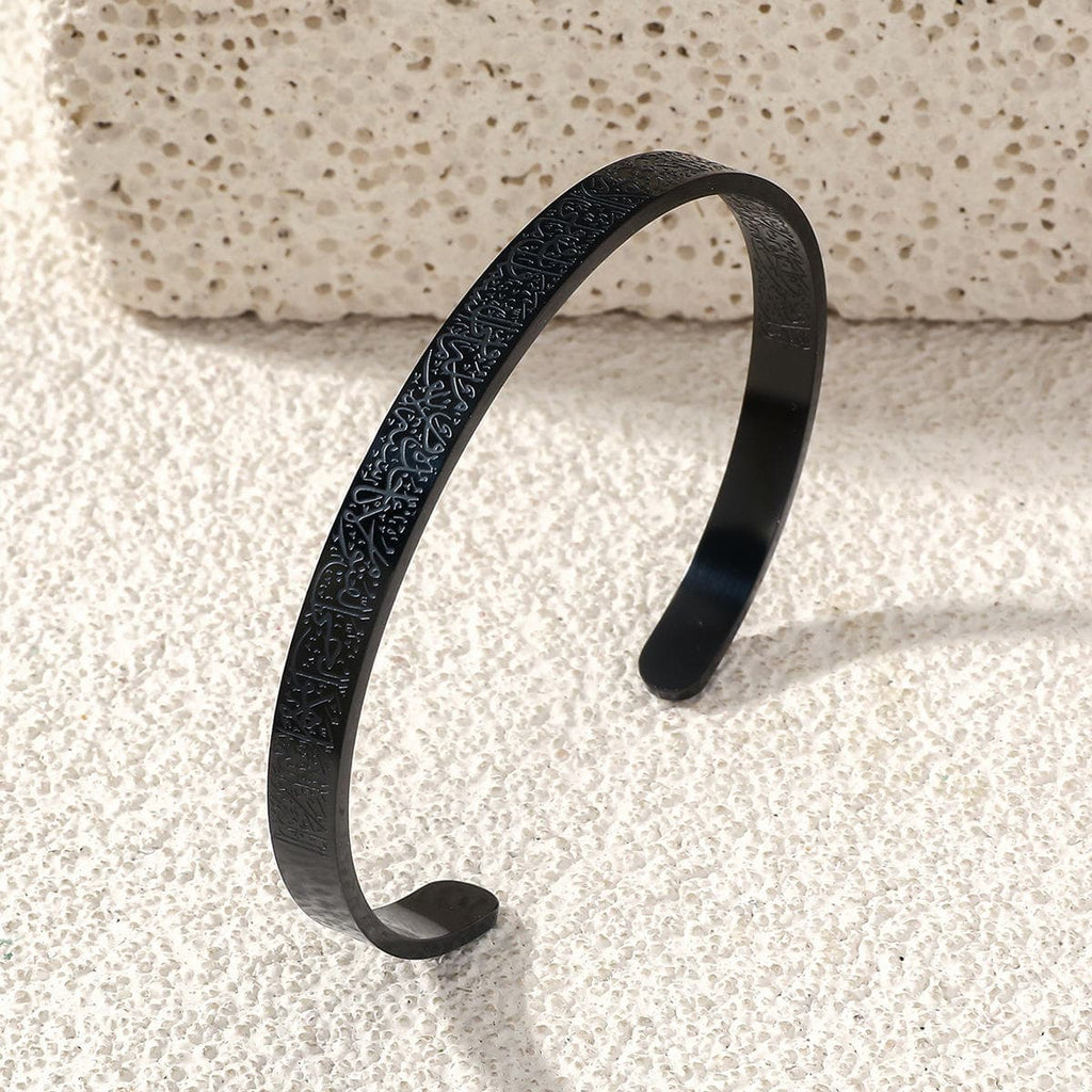 CIGAONI Pure Sanctuary Ayatul Kursi matte black open cuff bangle with Arabic calligraphy engraving on travertine surface

