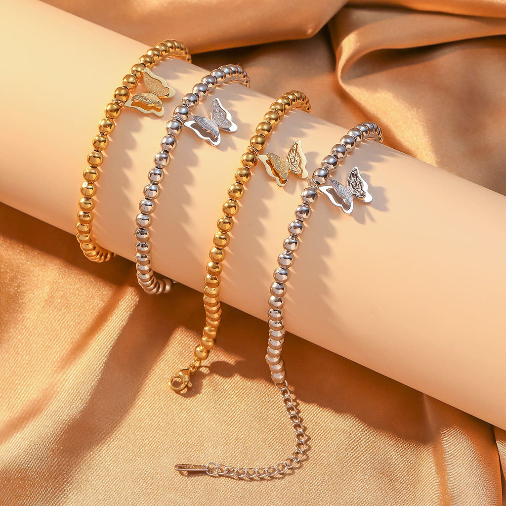 CIGAONI Wings of Amal gold butterfly beaded bracelet worn on wrist, 18K gold finish, double-layer filigree butterfly charm, 316L stainless steel