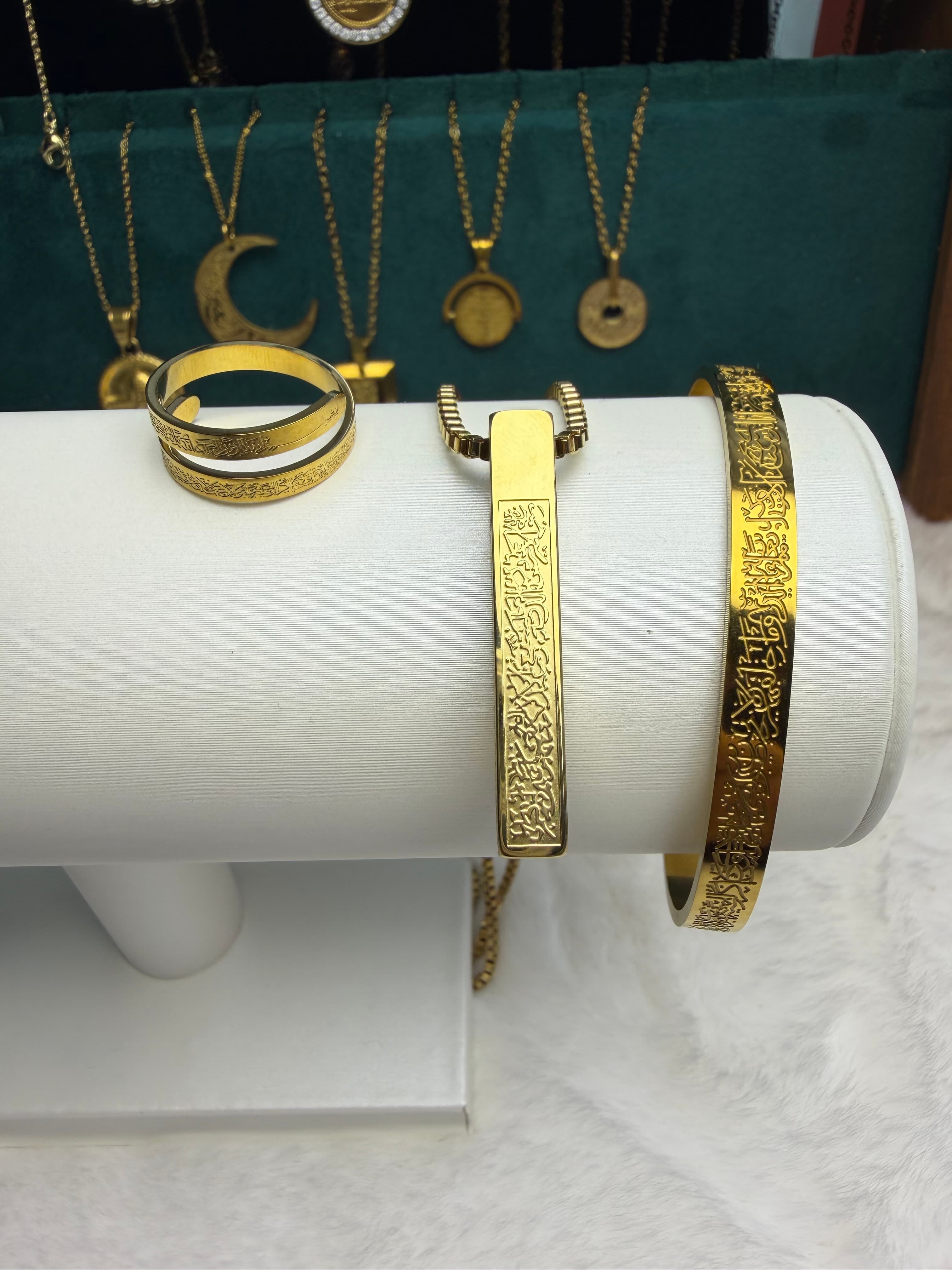 CIGAONI Sacred Trinity 18K gold plated Ayatul Kursi bangle and necklace set displayed on white jewelry stand