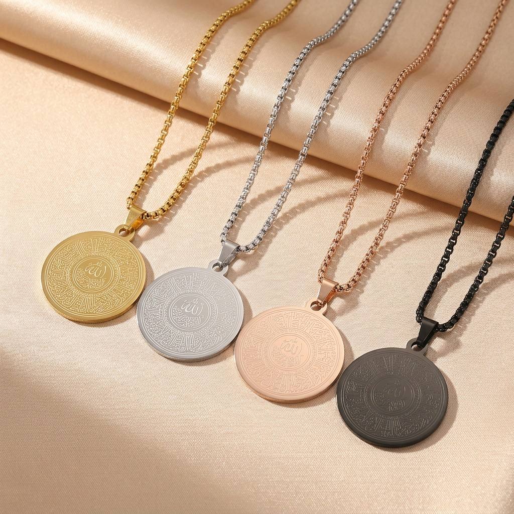 CIGAONI The Center Allah Medallion Necklace in all four finishes - Gold, Silver, Rose Gold and Matte Black - laid flat on champagne satin fabric