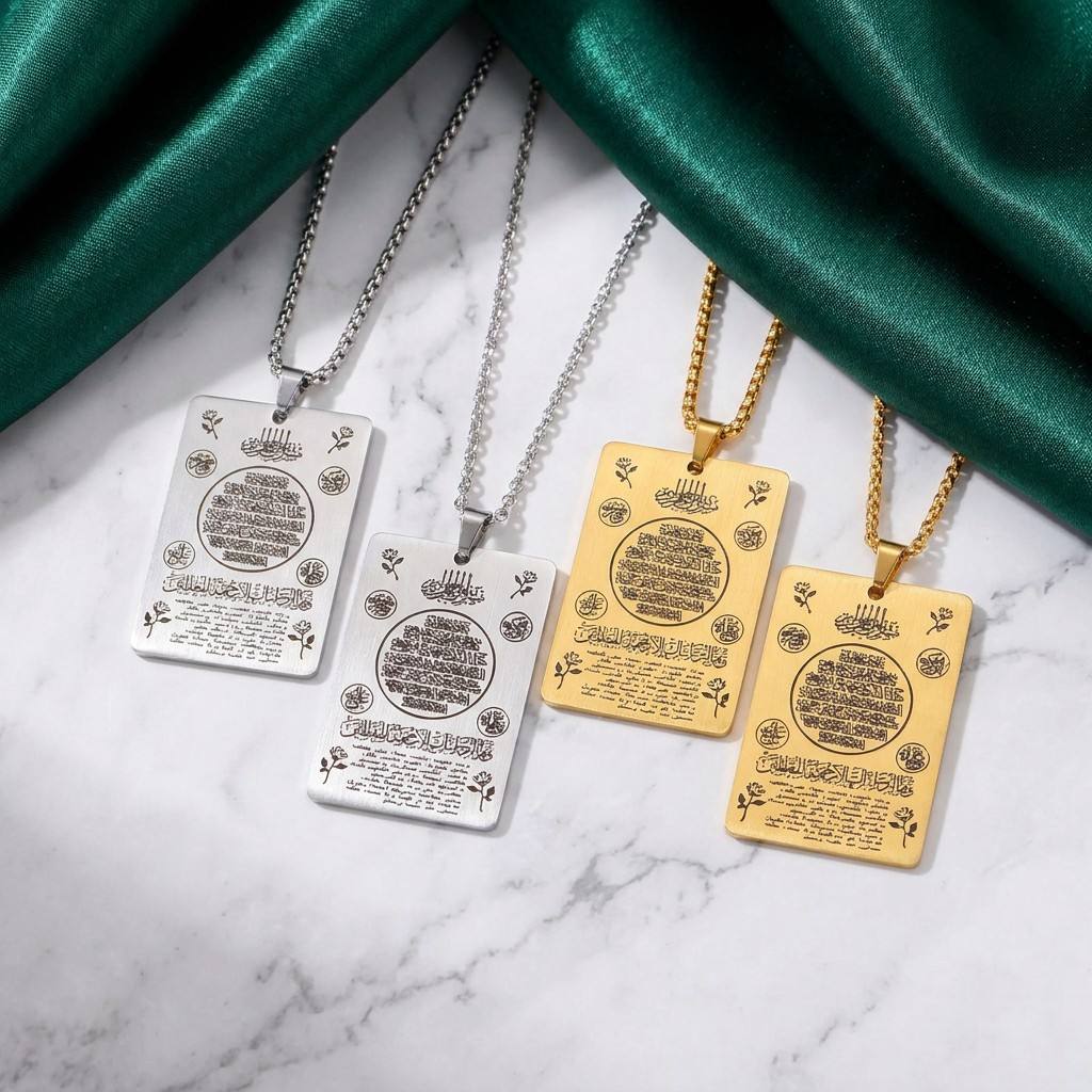 CIGAONI Heritage Tablet full Ayatul Kursi plaque necklaces in silver and gold with floral motifs displayed on white marble with green silk backdrop