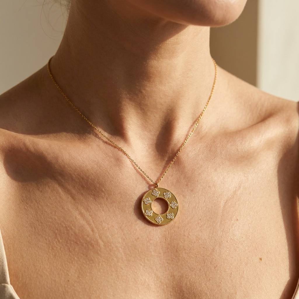Gold four-leaf clover disc necklace worn on neck close-up - CIGAONI