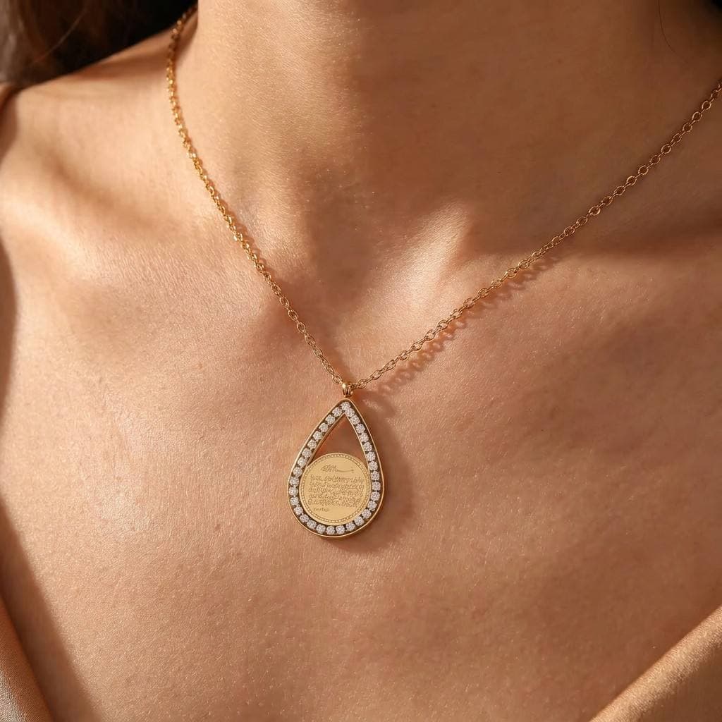 Close-up of CIGAONI teardrop pendant necklace worn on neck, showcasing delicate gold chain and luminous white stone