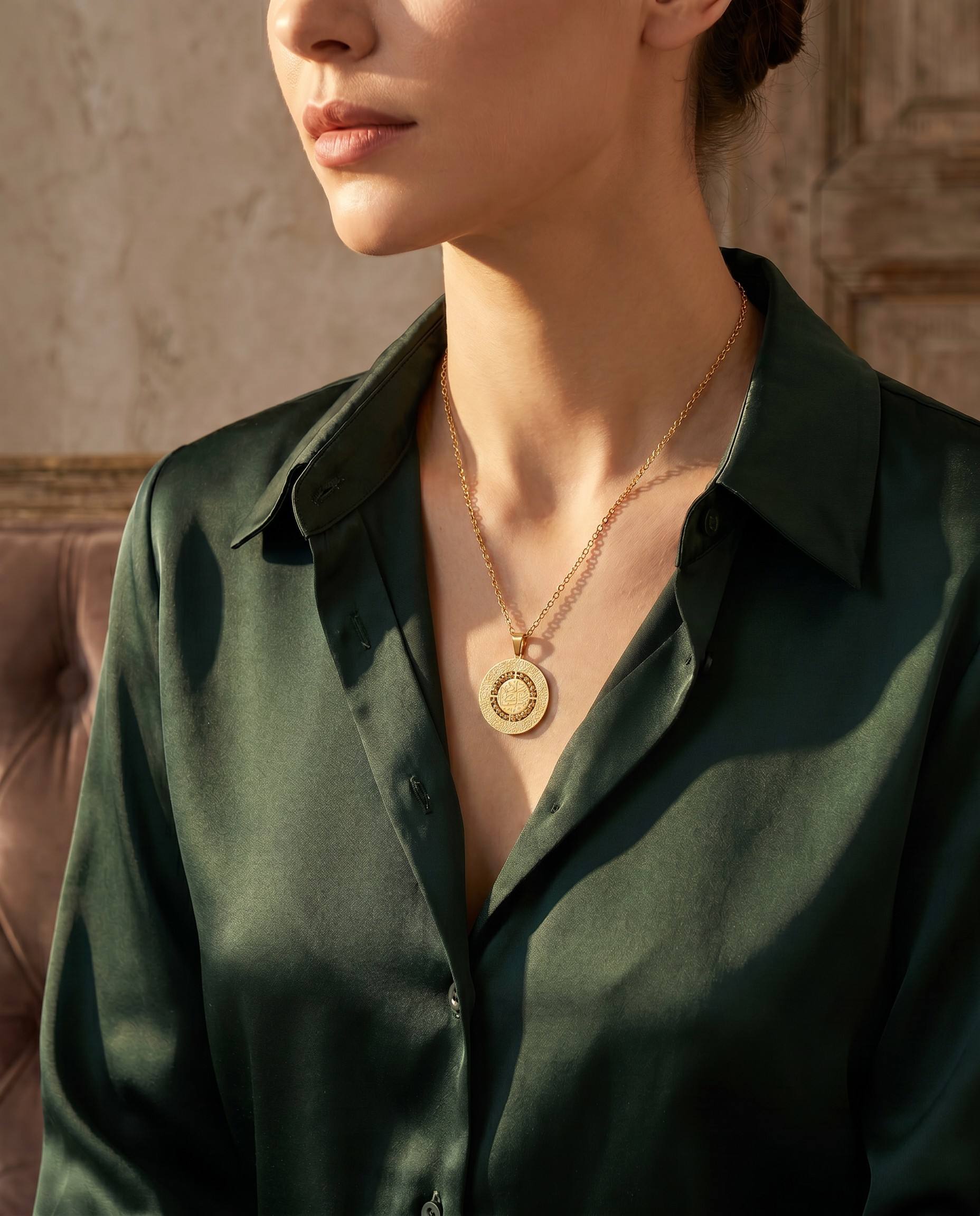 Triple-layered spinning necklace with Allah script and Ayatul Kursi engraving worn by model on green silk - CIGAONI