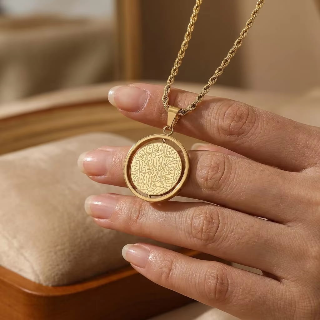 Close-up of gold rotating coin necklace - Premium 18K gold plated spiritual jewelry with intricate micro-engraved sacred script by Cigaoni