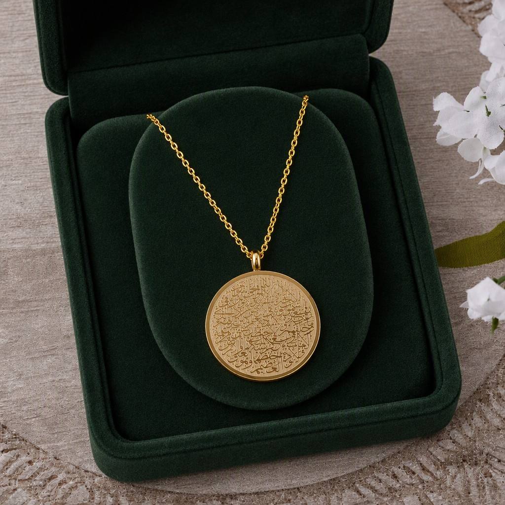 CIGAONI 18K Gold Ayatul Kursi Circle Medallion Necklace displayed in open emerald green luxury jewelry gift box with white flowers