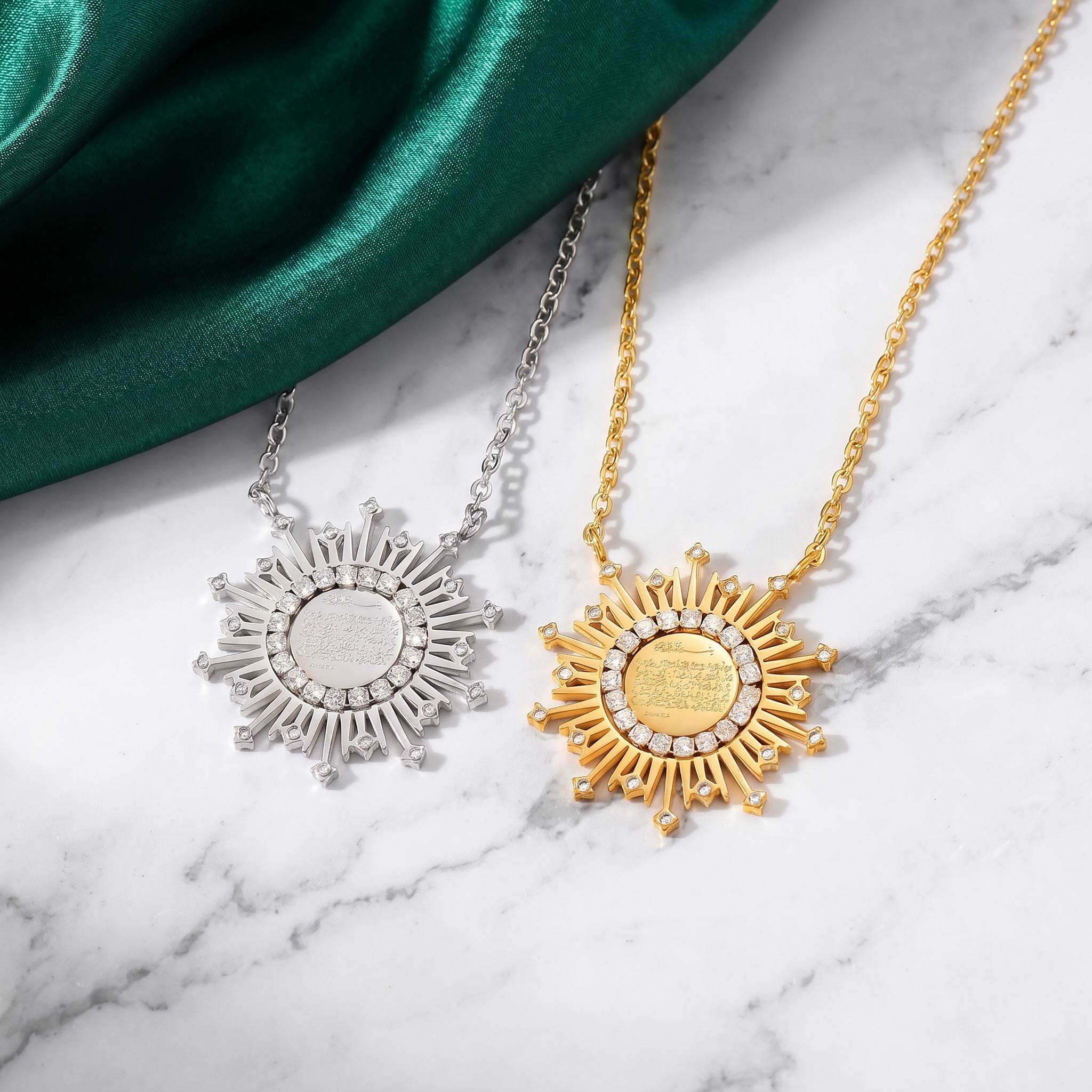 CIGAONI Radiant Shield Ayatul Kursi sunburst necklace in gold and silver, displayed on marble with green silk backdrop