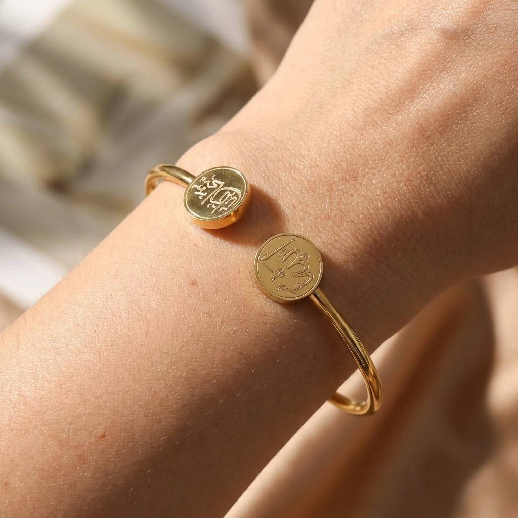 Elegant model wearing CIGAONI gold open cuff bangle - Sophisticated Islamic protection jewelry with Ma Shaa Allah engraving


