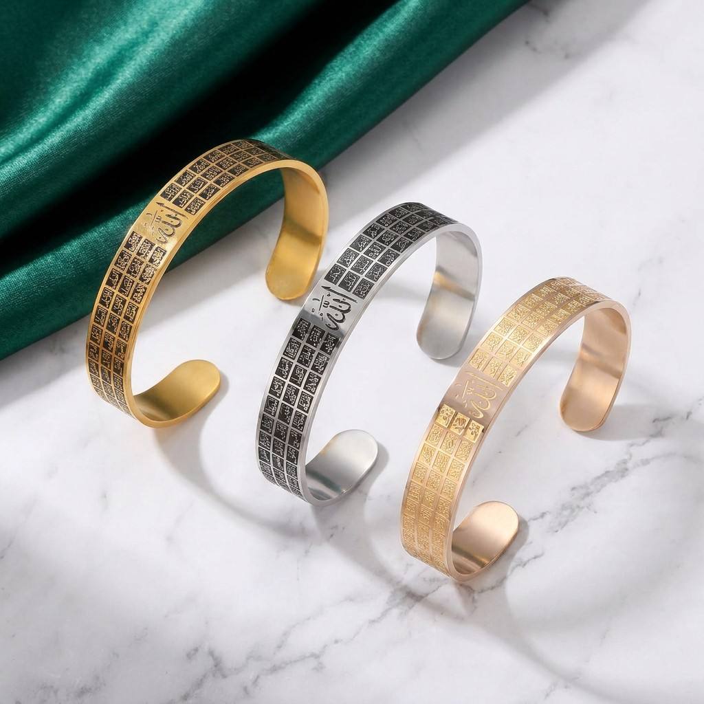 CIGAONI Asma-ul-Husna open cuff bangle in gold, silver-black and rose gold variants with 99 Names of Allah engraving on marble surface