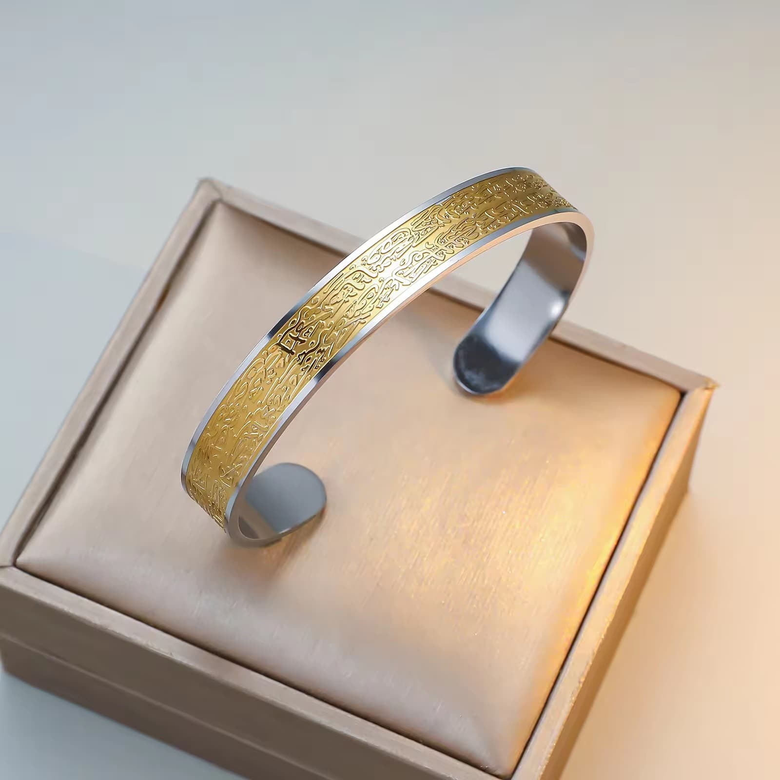 CIGAONI Sovereign Shield silver-gold two-tone Ayatul Kursi open cuff bangle with gold engraved face and silver inner band, on beige gift box