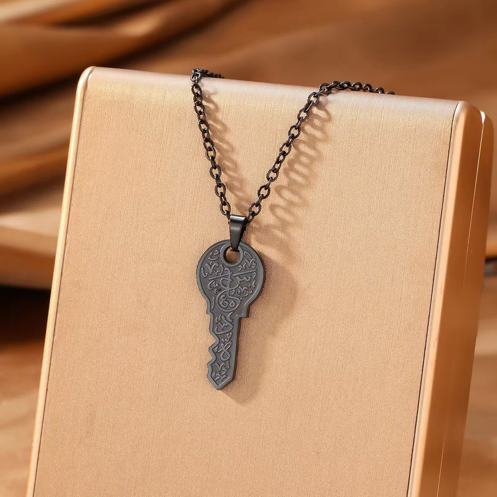 Gold key pendant necklace on beige gift box