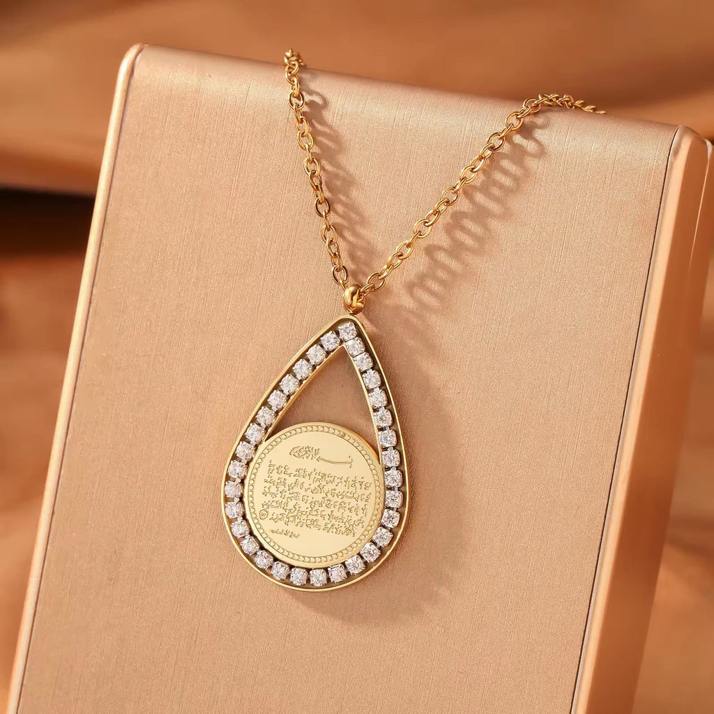 CIGAONI teardrop pendant necklace in gold finish with white mother-of-pearl center stone, front view on neutral background