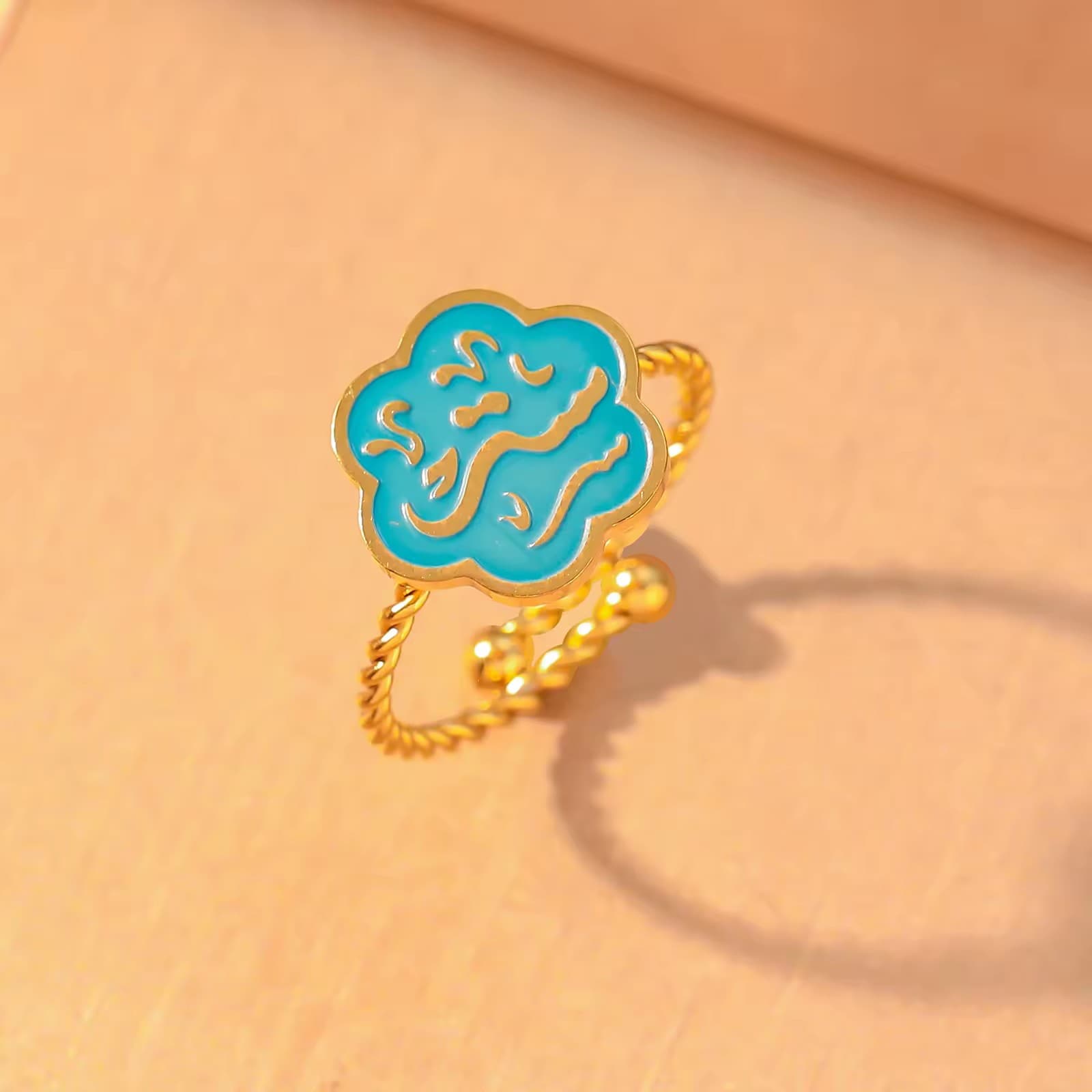 CIGAONI Bloom of Salam teal enamel Arabic calligraphy flower ring in 18K gold – close-up product shot on neutral background

