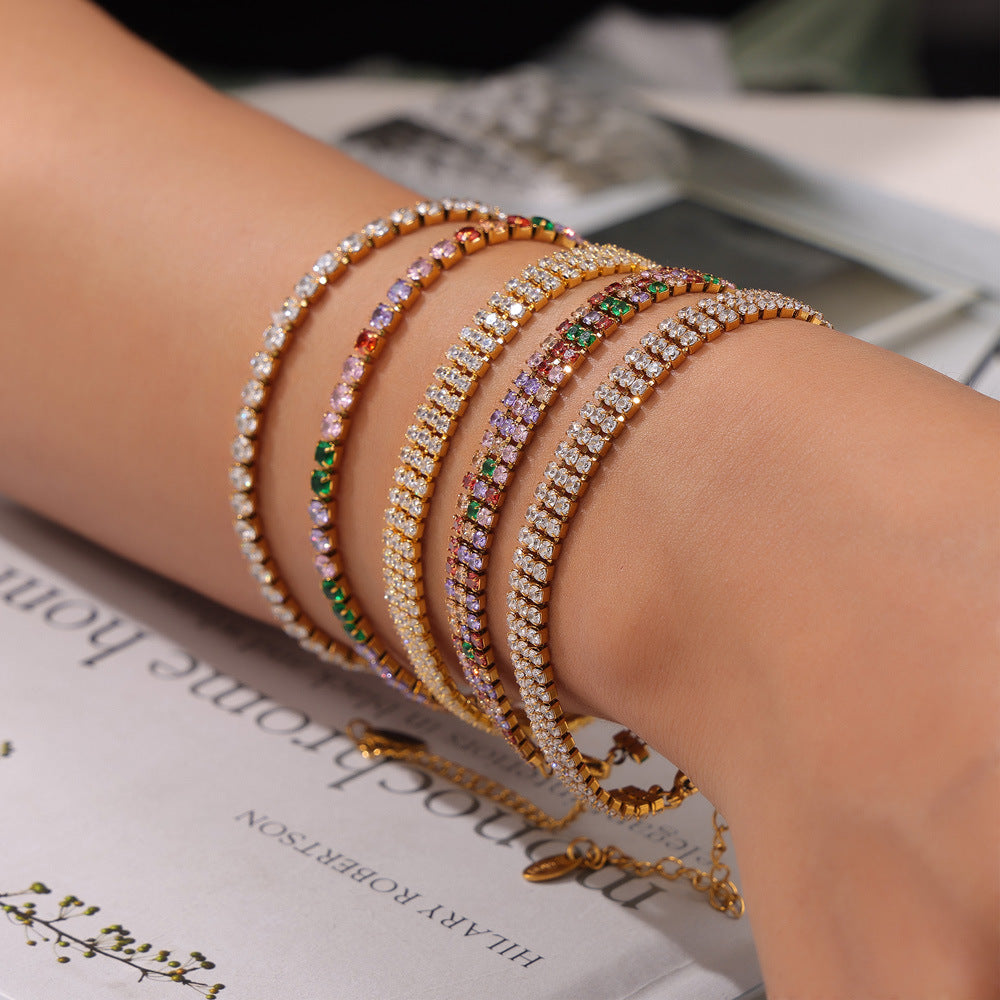 CIGAONI stacked gold tennis bracelets with multicolor zirconia worn on wrist, layered jewelry look

