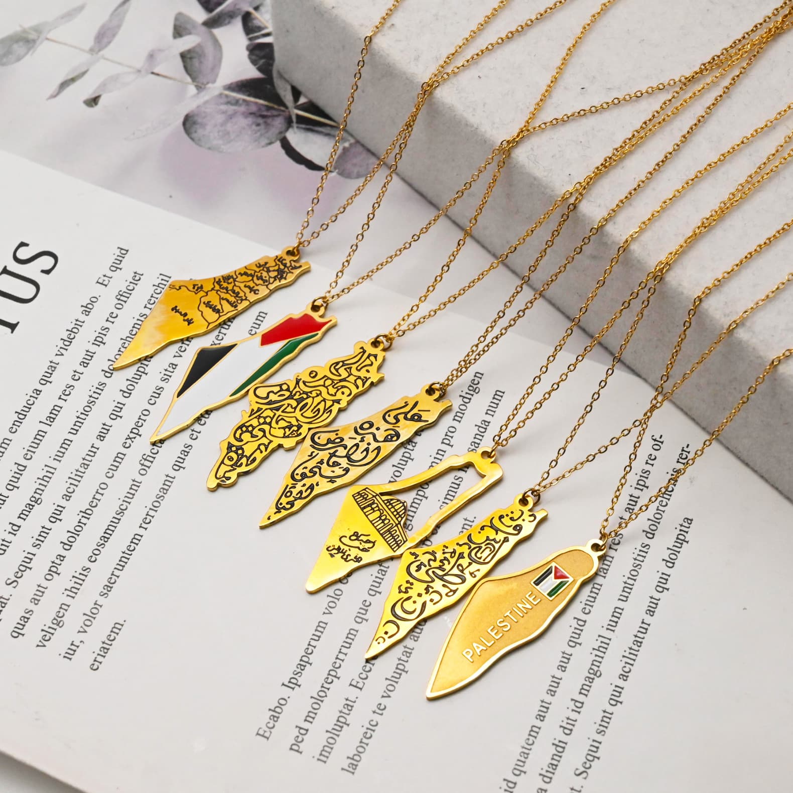 Multiple gold Palestine map necklace variants displayed in red gift box - CIGAONI