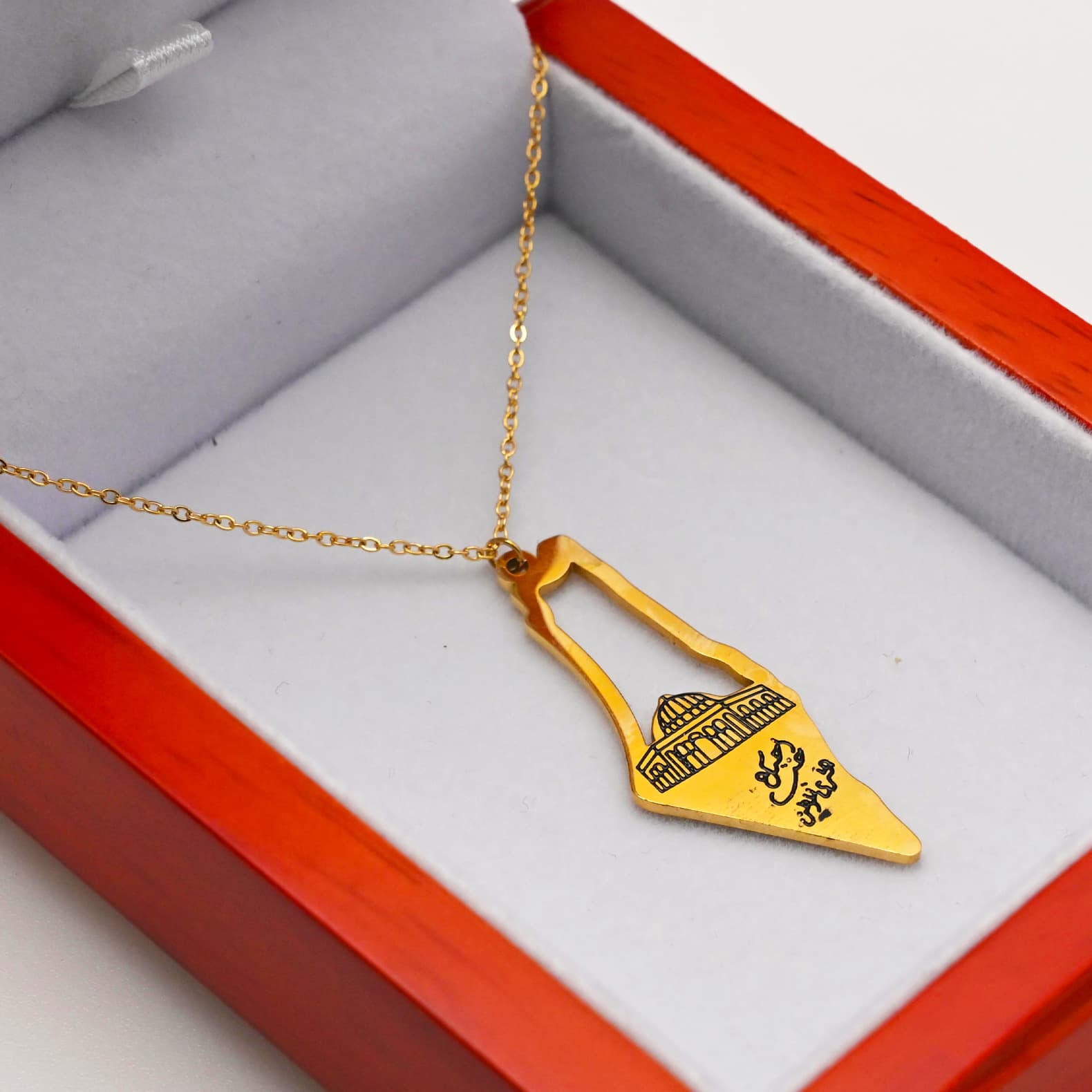 Multiple gold Palestine map necklace variants displayed in red gift box - CIGAONI