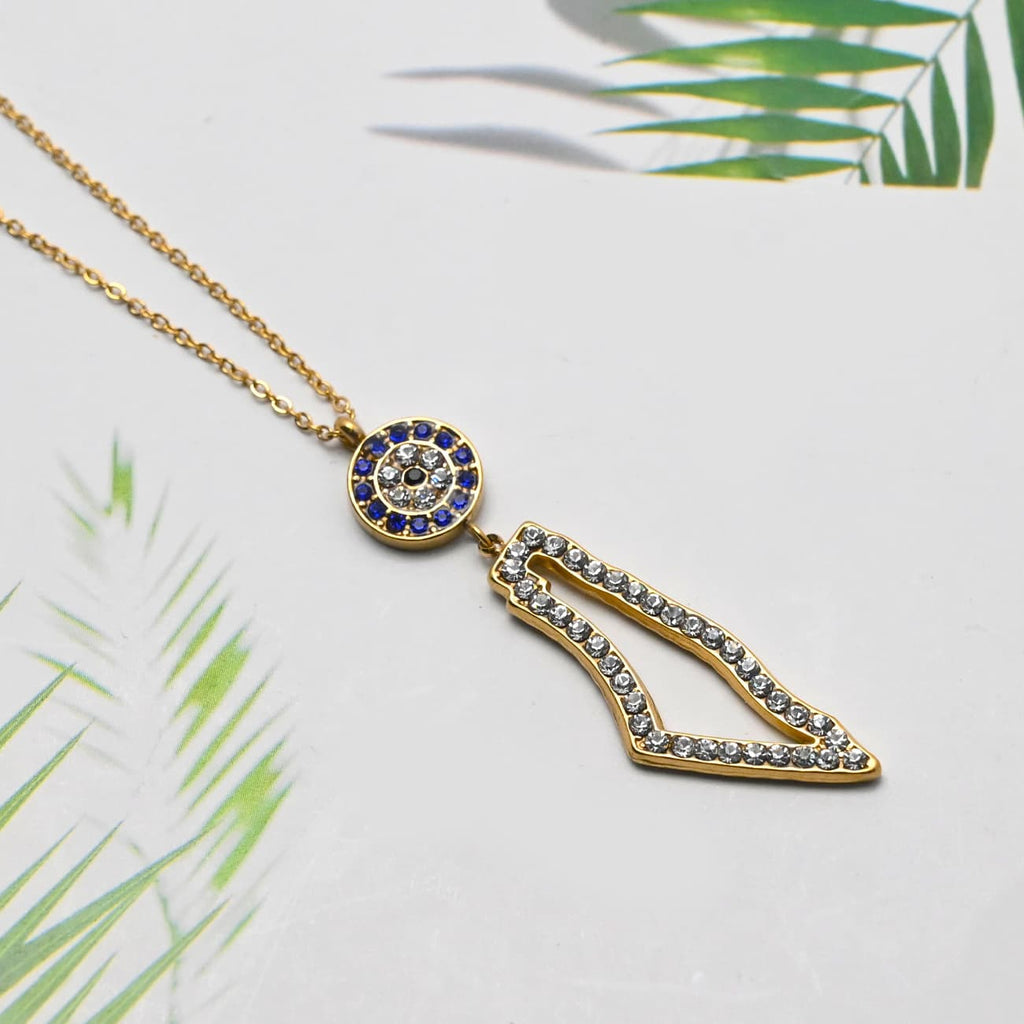 Eternal Guardian Necklace gold geometric arrow pendant with crystal eye detail on tropical leaf background - CIGAONI