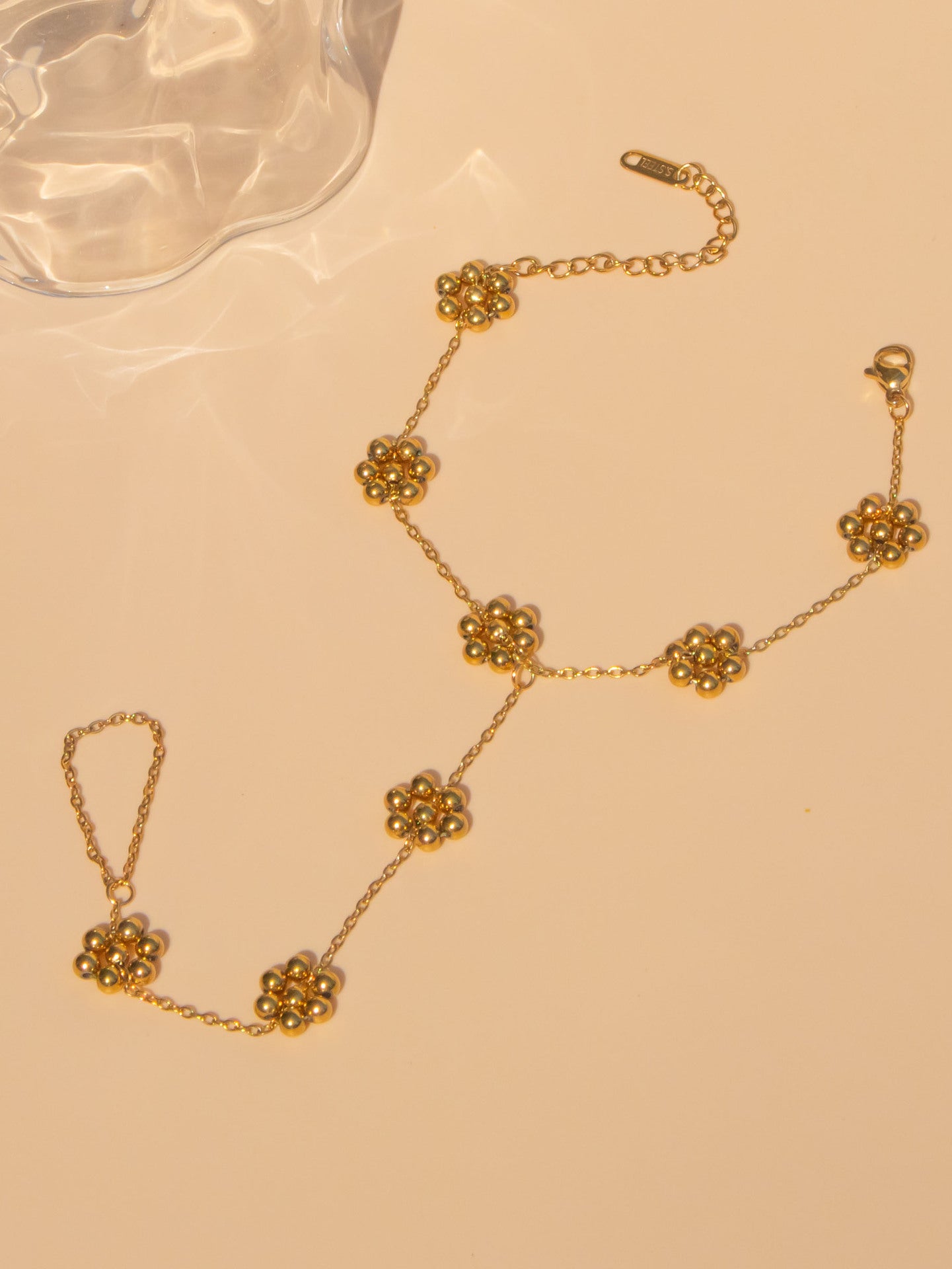 Six flower link gold hand harness - Sophisticated boho-chic slave bracelet with intricate artisan detail

