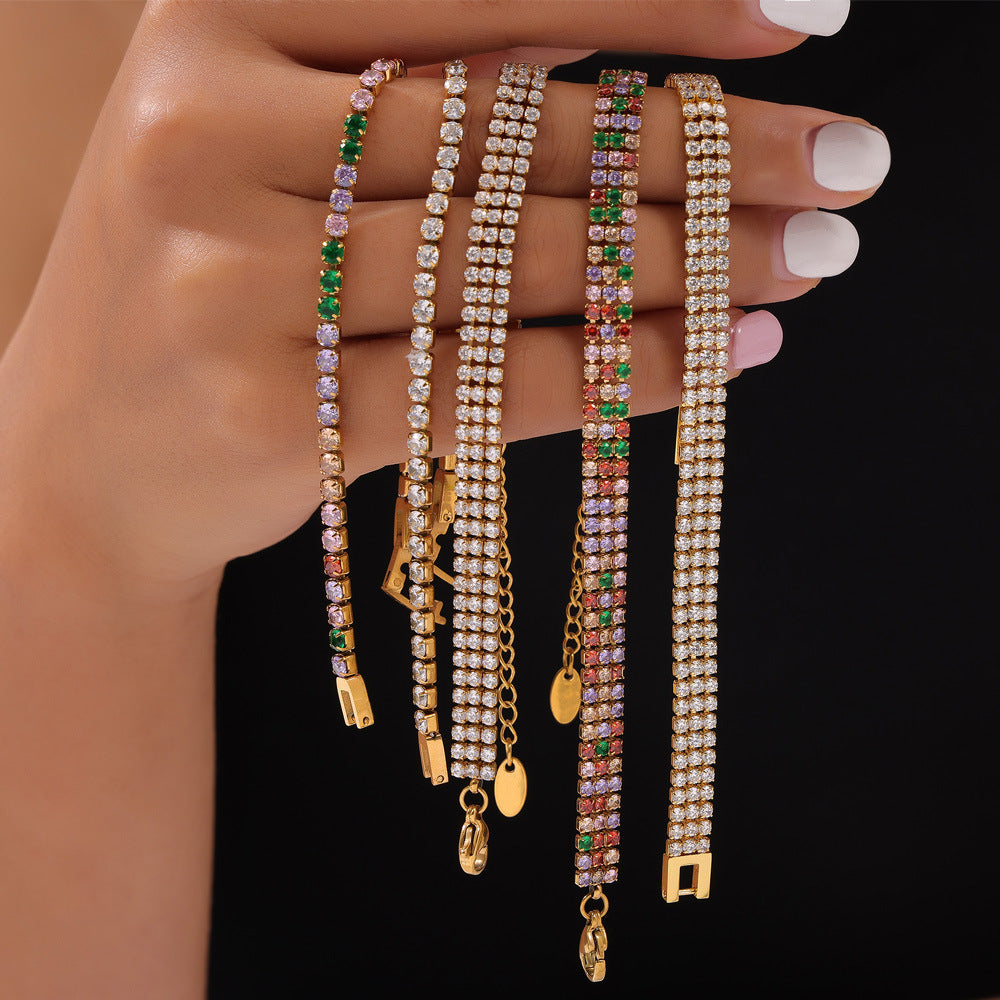 CIGAONI five gold tennis bracelets with colorful cubic zirconia displayed on jewelry roll stand

