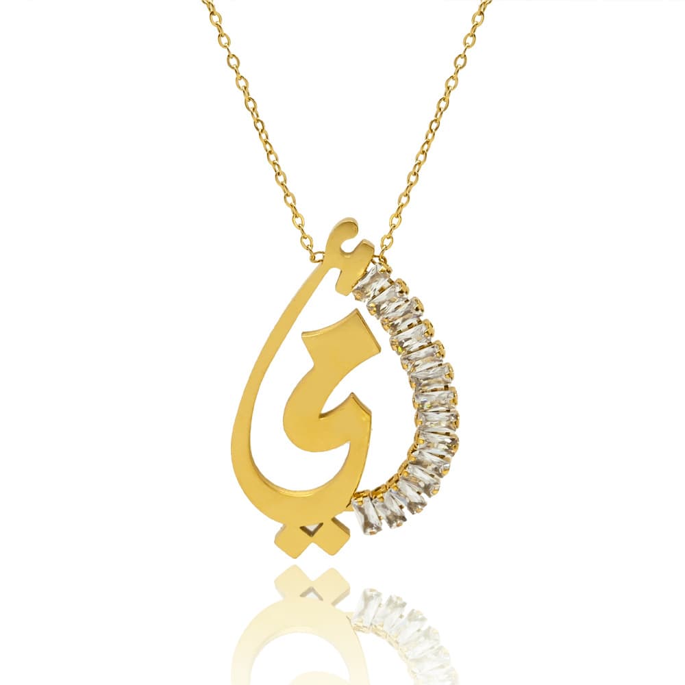Gold Arabic calligraphy teardrop pendant necklace with green crystal, isolated on white background
