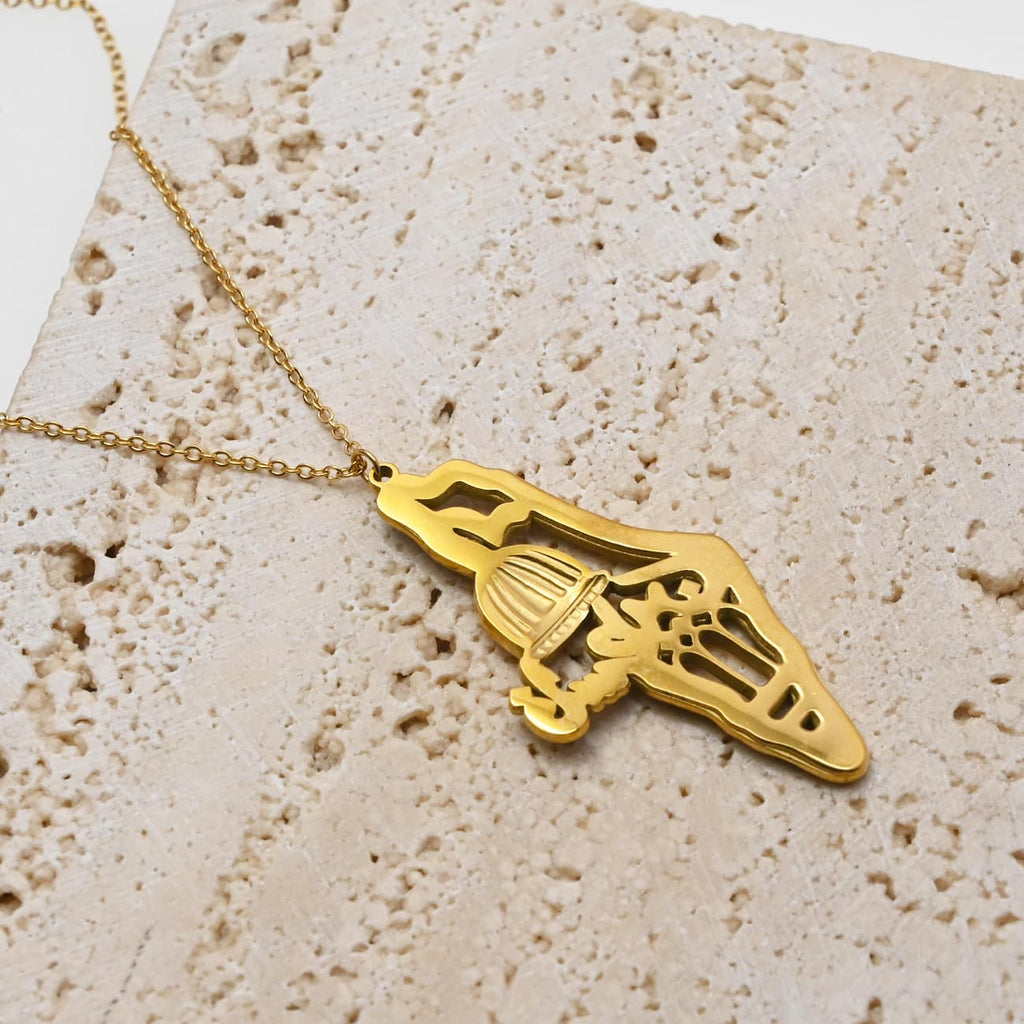 Dainty Palestine map necklace flat lay on sandy beige surface - CIGAONI