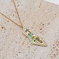 Colorful enamel art pendant necklace on sandy beige background - CIGAONI