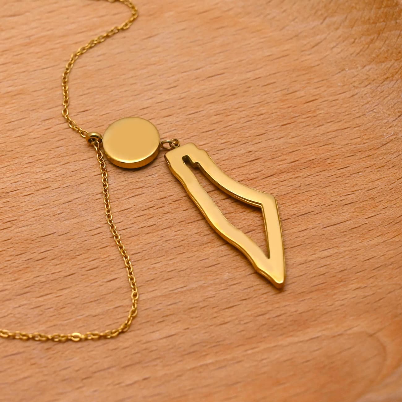 Eternal Guardian Necklace gold arrow outline pendant necklace on warm background - CIGAONI